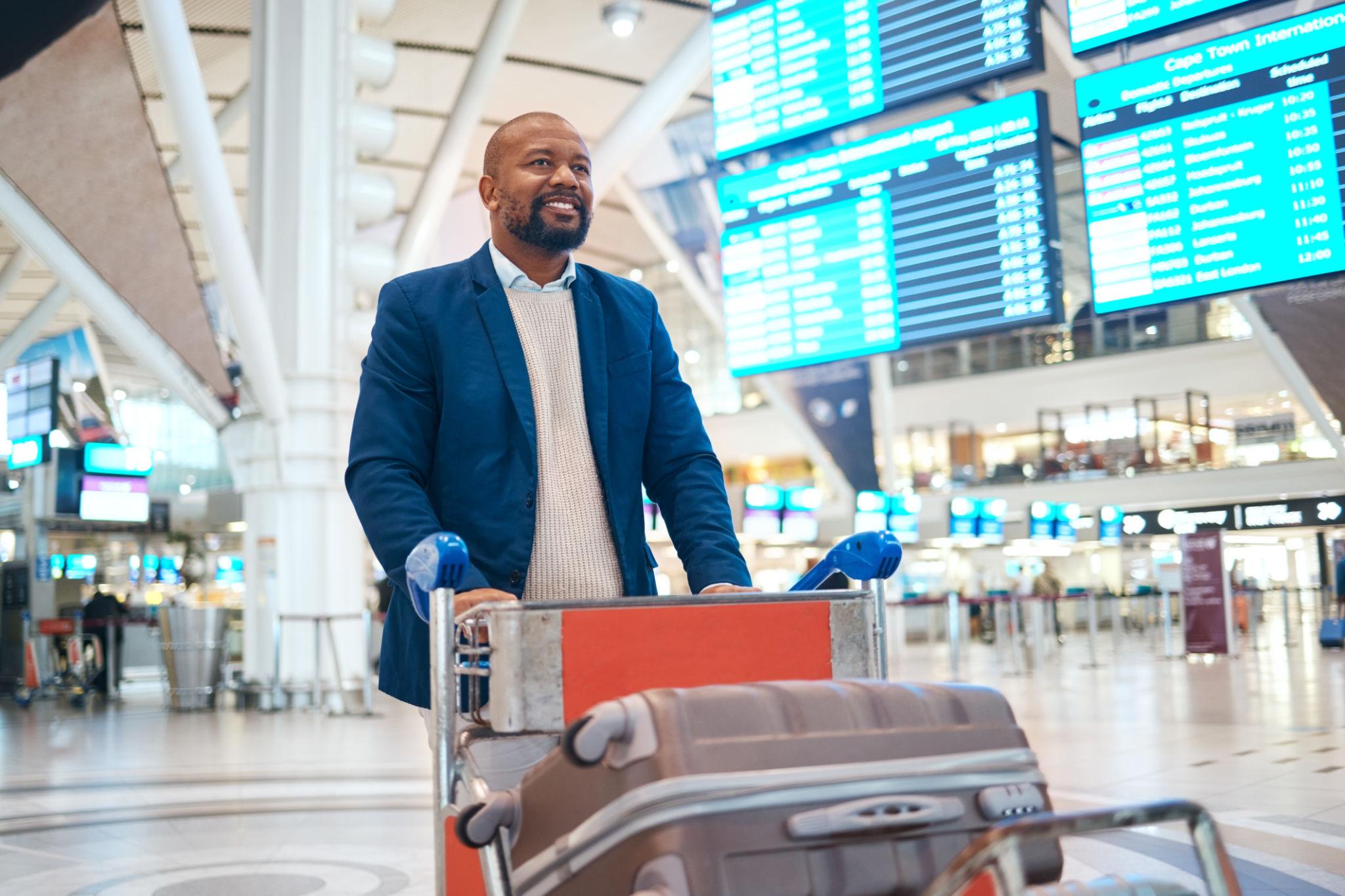 a man pushing trollery with bags at airport
