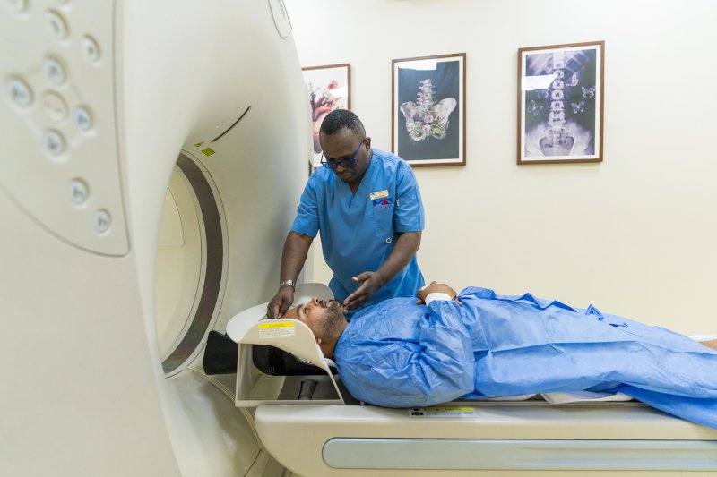 a patient being guided into the radiology machine